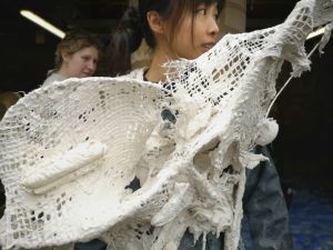 Fashion student modelling plaster their plaster garment